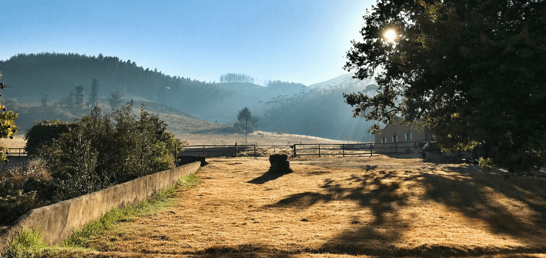 Scenic farm landscape with mountains in the background